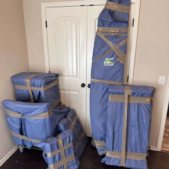 Furniture wrapped in moving blankets