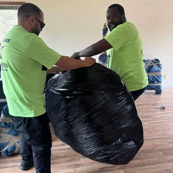 Two movers wrapping an item