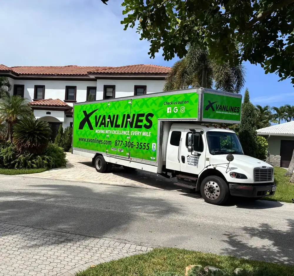 X Van Lines moving truck parked outside a client's home